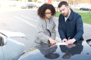 Two drivers settling insurance claims.