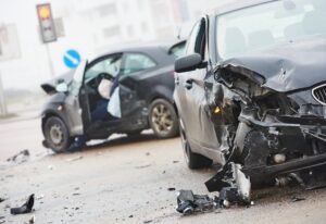 Two car crash in the middle of the road.